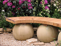 Garden bench made of wood on top of round stones