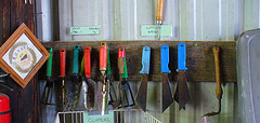 Various garden tools hanging on the cabinet